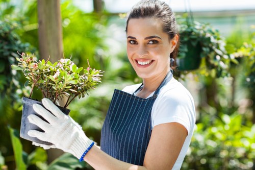 Staff member pruning a hedge representing ethical garden work
